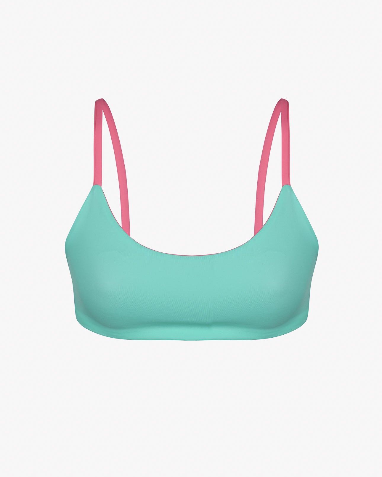 Das Sassy Bikini Oberteil reversibel von Main Design ist ein wendbares Bikinioberteil mit türkisfarbenem BH und rosa Trägern auf weißem Hintergrund, hergestellt aus chlorbeständigem Material für Langlebigkeit.