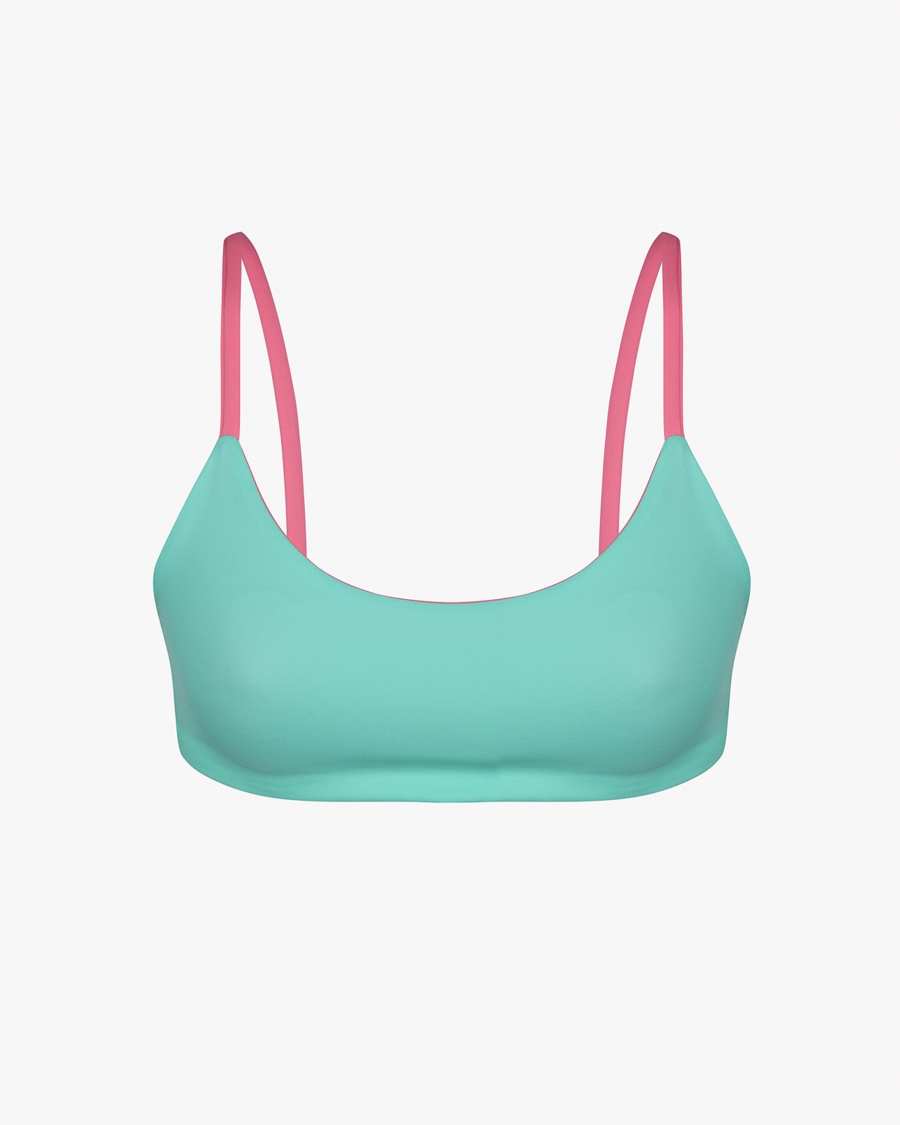 Das Sassy Bikini Oberteil reversibel von Main Design ist ein wendbares Bikinioberteil mit türkisfarbenem BH und rosa Trägern auf weißem Hintergrund, hergestellt aus chlorbeständigem Material für Langlebigkeit.