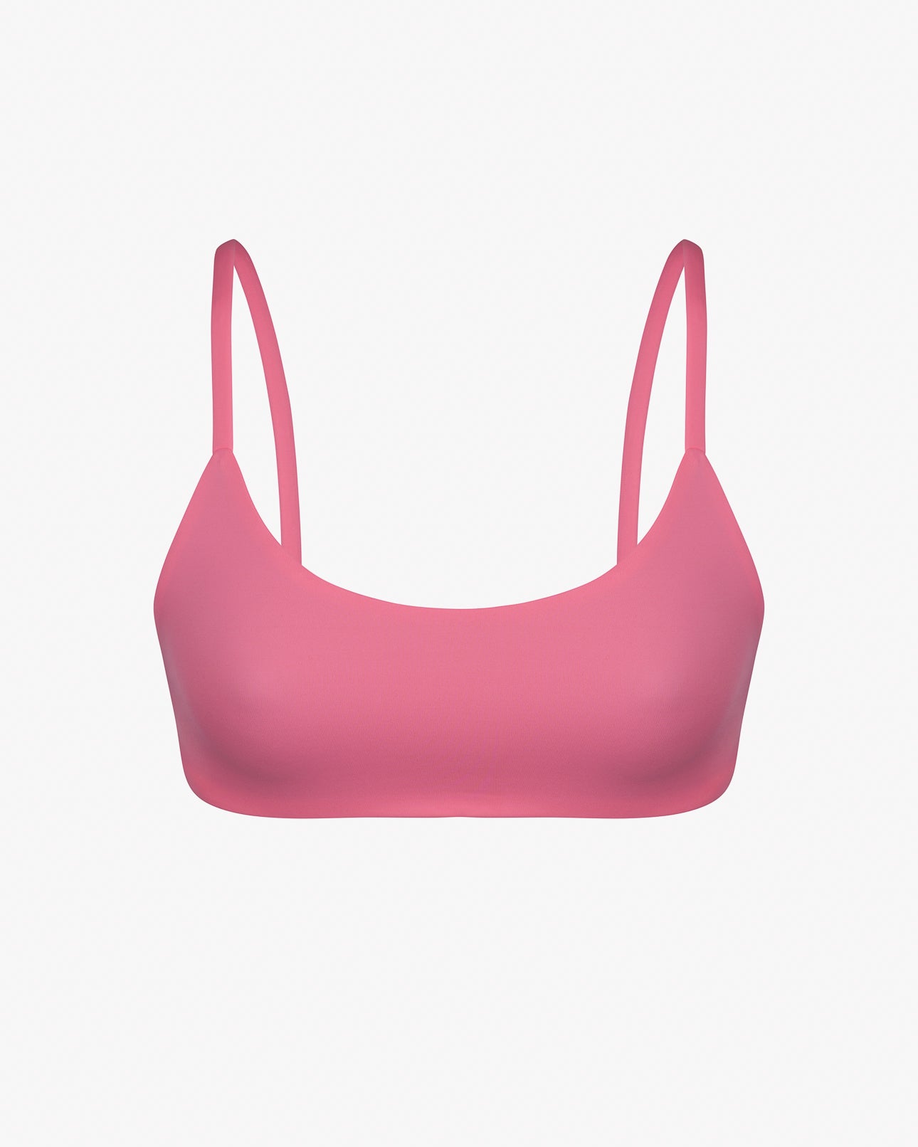 Das Sassy Bikini Oberteil reversibel von Main Design ist ein pinkfarbener Sport-BH mit dünnen Trägern aus glattem, dehnbarem und chlorresistentem Stoff. Er ist perfekt wendbar und kann auf einem schlichten weißen Hintergrund getragen werden.