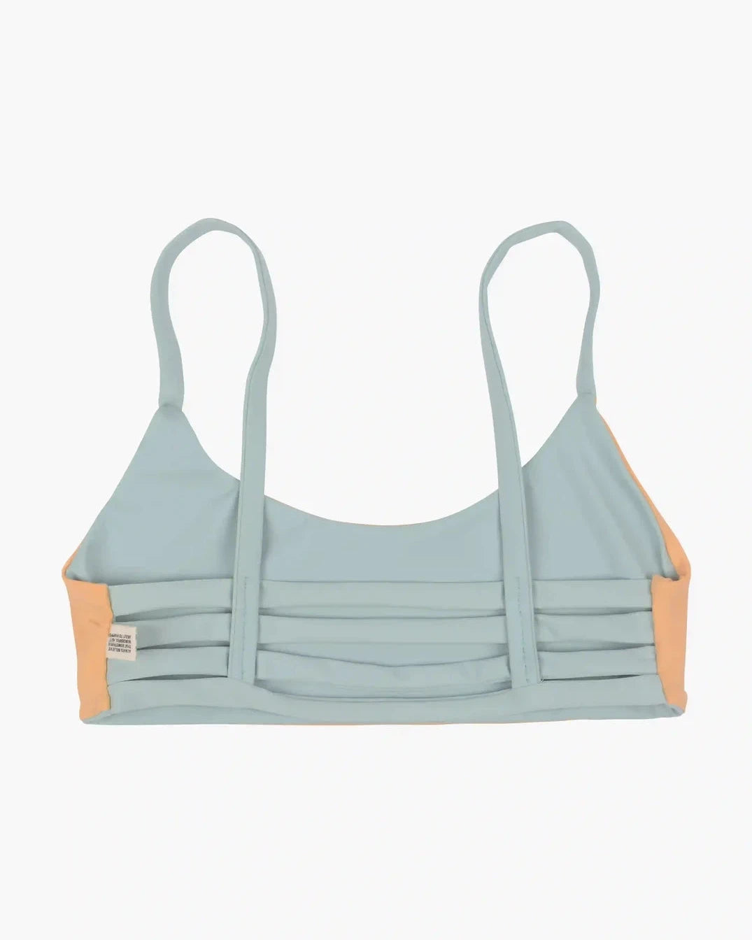 Das Sassy Bikini Oberteil Reversibel von Main Design in Pastellgrün und Pfirsich mit dünnen Trägern und Streifenmuster auf der Rückseite wurde auf einen schlichten hellen Hintergrund gelegt.