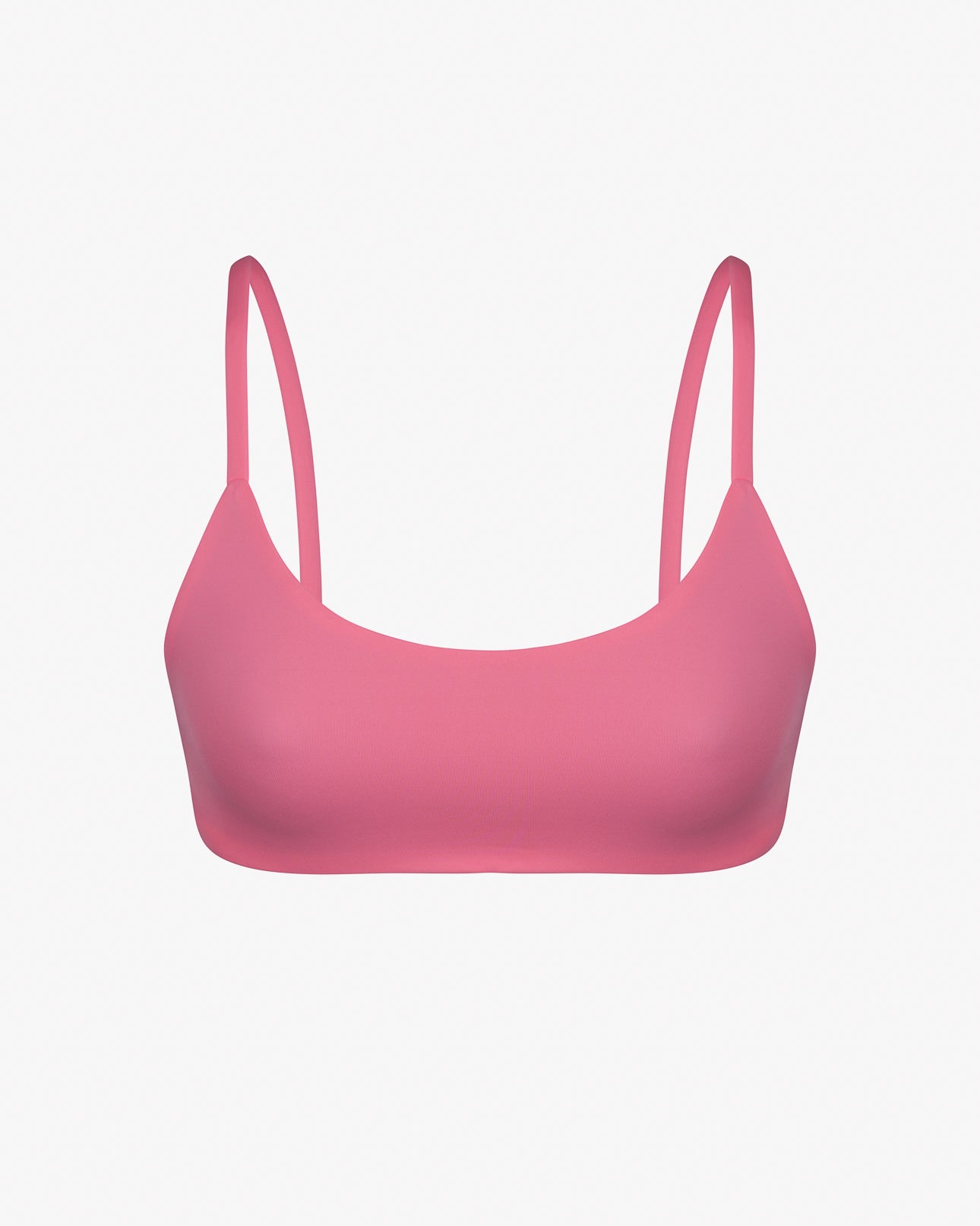 Das Sassy Bikini Oberteil reversibel von Main Design ist ein pinkfarbener Sport-BH mit dünnen Trägern aus glattem, dehnbarem und chlorresistentem Stoff. Er ist perfekt wendbar und kann auf einem schlichten weißen Hintergrund getragen werden.