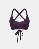 Das Charm Surf Bikini-Oberteil von Main Design ist ein dunkelvioletter Sport-BH mit überkreuzten Trägern und einem Verschluss zum Binden. Er ist aus chlorresistentem Material mit UPF 50+ Sonnenschutz hergestellt und wird von hinten auf weißem Hintergrund gezeigt.