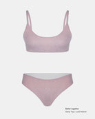 Hellrosafarbenes Sassy Glitter Bikini Oberteil von Main Design auf weißem Grund. Das Oberteil hat einen Rundhalsausschnitt mit dicken Trägern und eine hochgezogene Hose. Text in der Ecke: "Besser zusammen Sassy Top | Luxe Bottom".