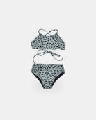 Der Nalu Mädchen Bikini von Main Design ist ein grauer Zweiteiler mit schwarzen, unregelmäßigen Punkten, der aus recycelten Materialien hergestellt wird. Das Oberteil hat überkreuzte Träger und die hoch taillierte Unterhose bietet UPF 50+ Sonnenschutz, dargestellt auf weißem Hintergrund.