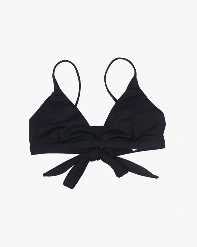 A black Adore Triangel Bikini Oberteil by Main Design with thin, verstellbare Schulterträger and a tie closure at the back. The fabric appears smooth and stretchy, suitable for swimwear. The design features a simple, classic triangle shape for the cups.